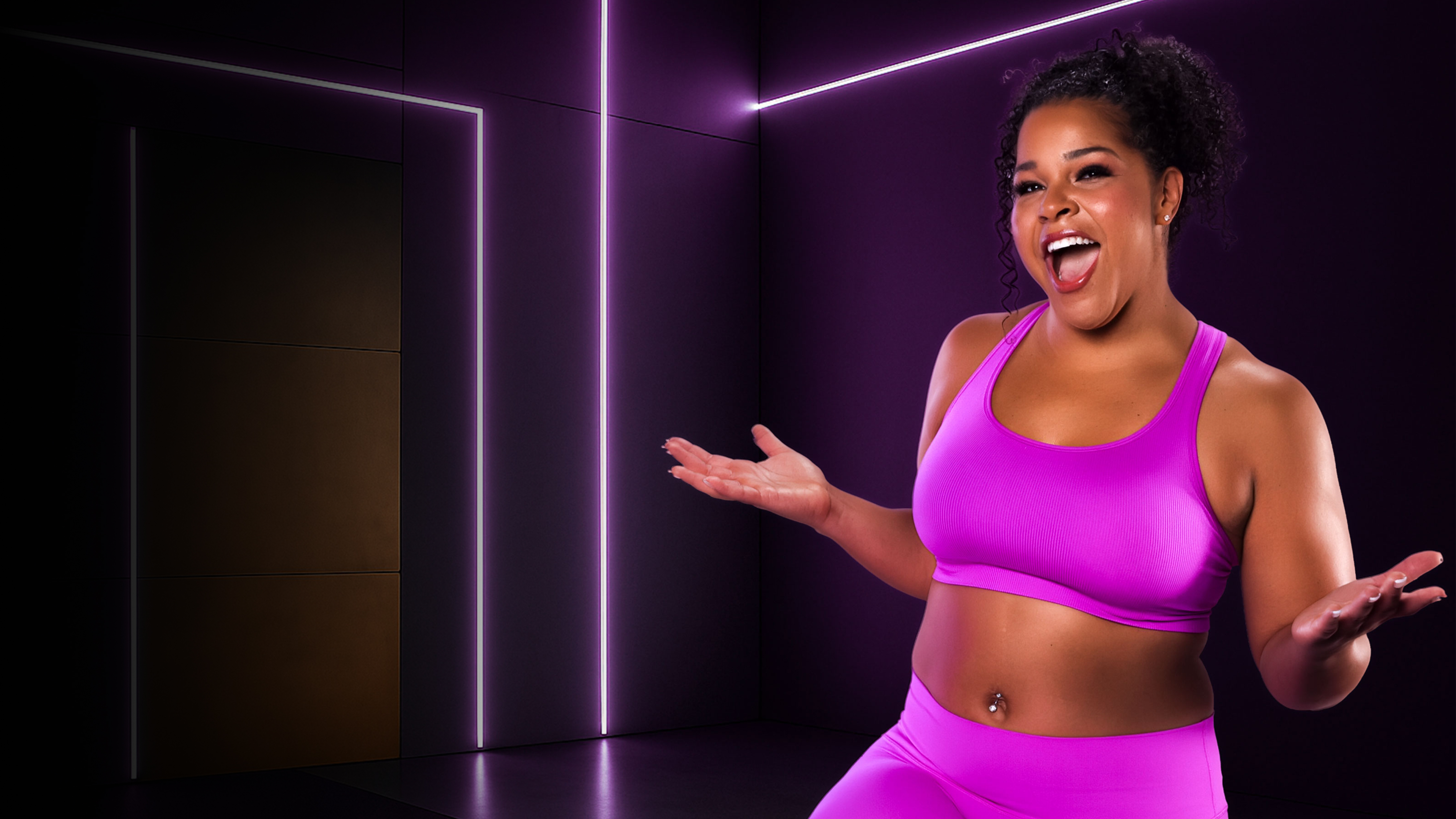 Woman in matching sports bra and leggings with her mouth open in excitement
