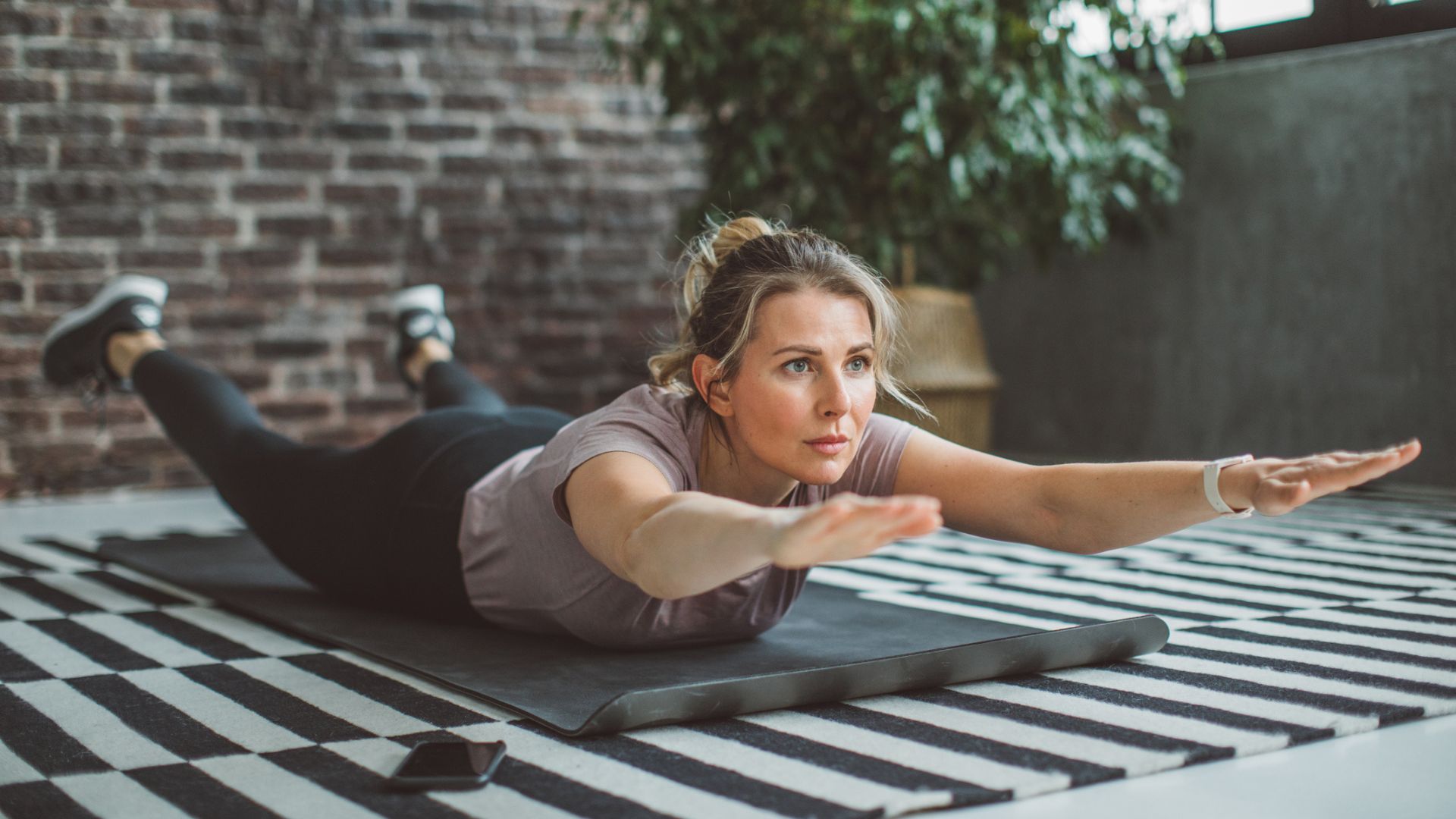 woman on mat in superman hold